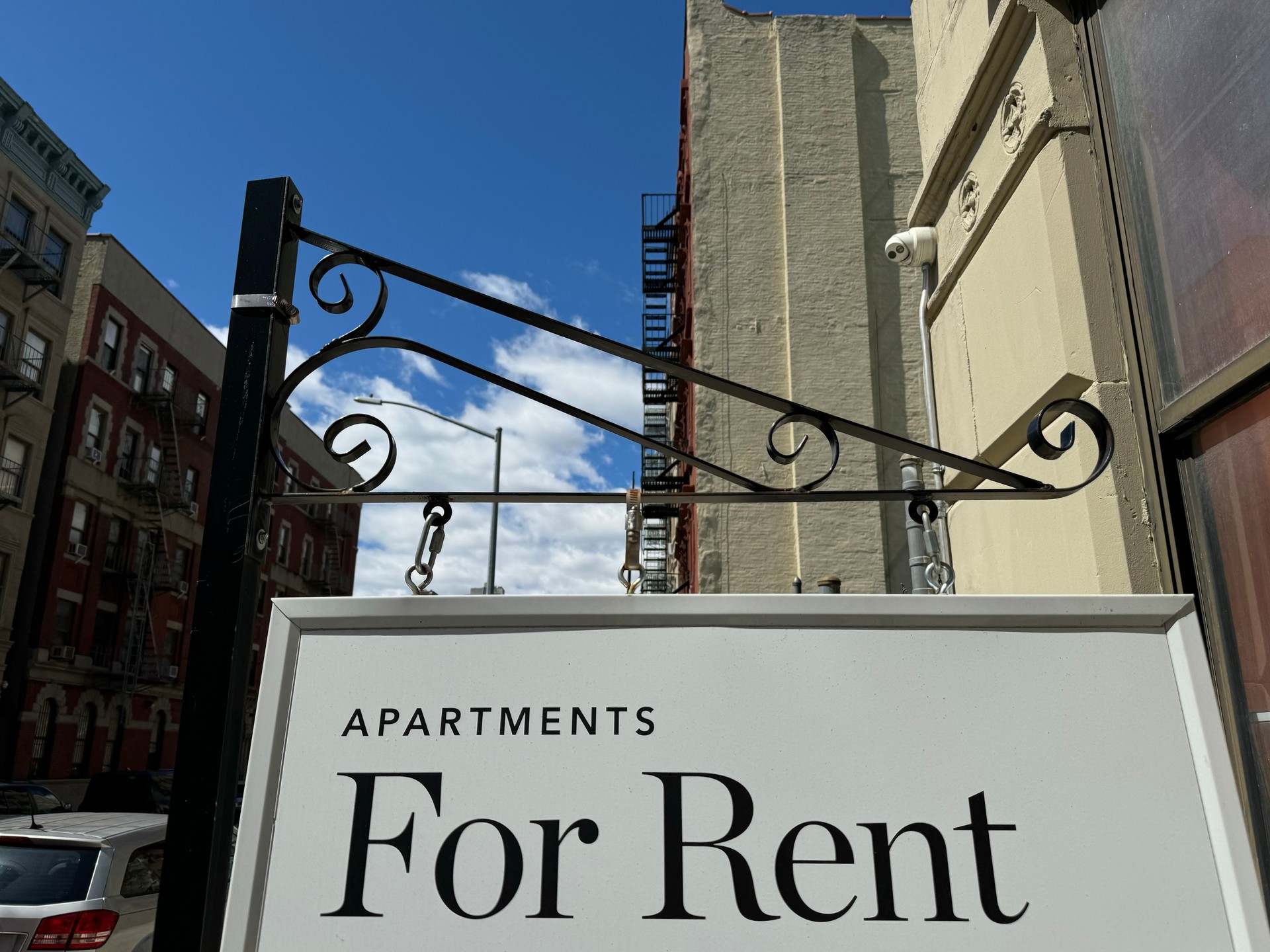 "Apartments for Rent" shingle hanging from a residential building in Harlem, New York City